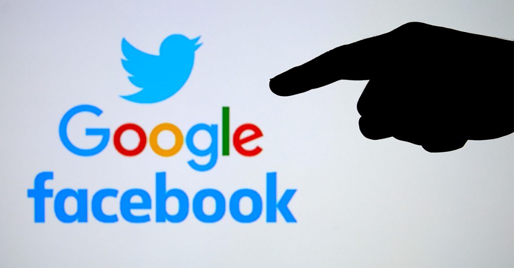 Logos for Twitter, Google, and Facebook with a silhouetted pointing hand in the foreground.