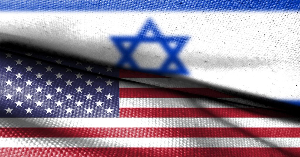 Israeli flag draped over a U.S. flag in a close-up fabric texture.