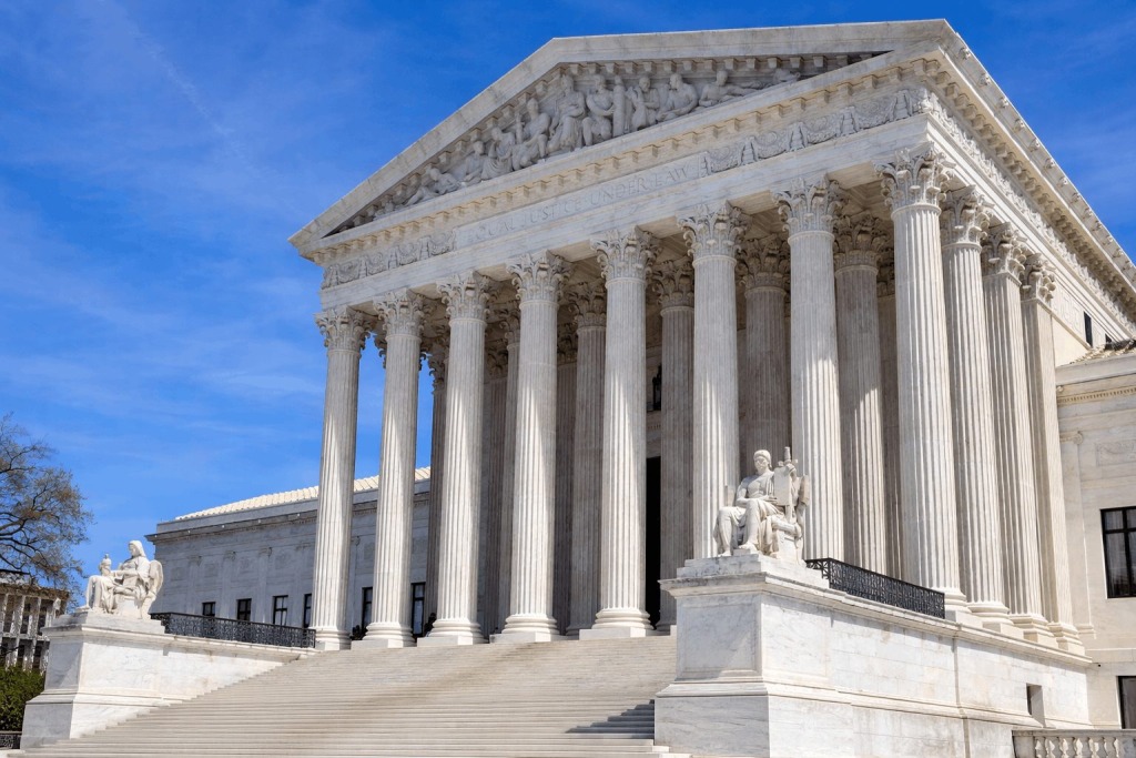 Supreme Court building under a clear sky.