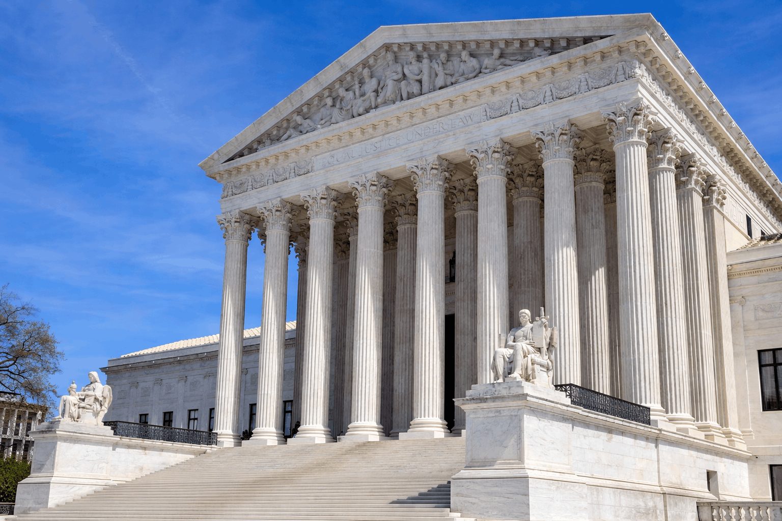 Supreme Court building under a clear sky.