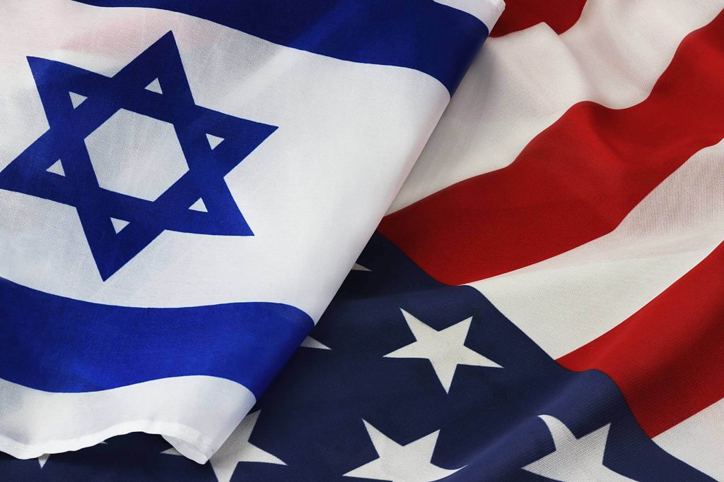 Close-up of intertwined Israeli and American flags symbolizing unity and allied defense.