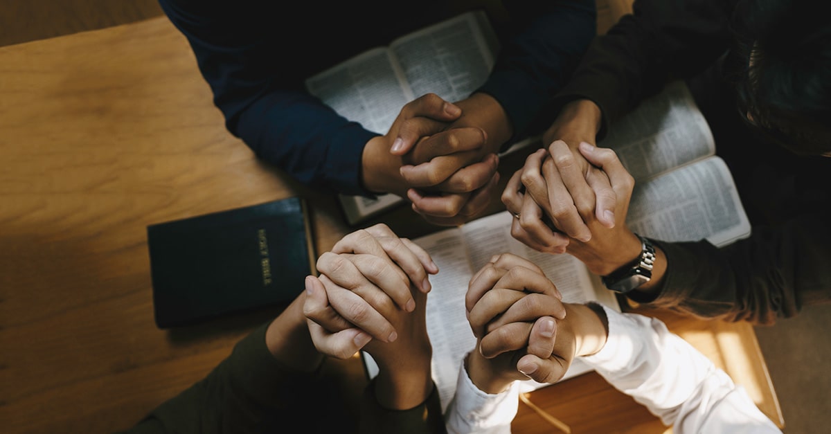 Christian students pray during association meeting