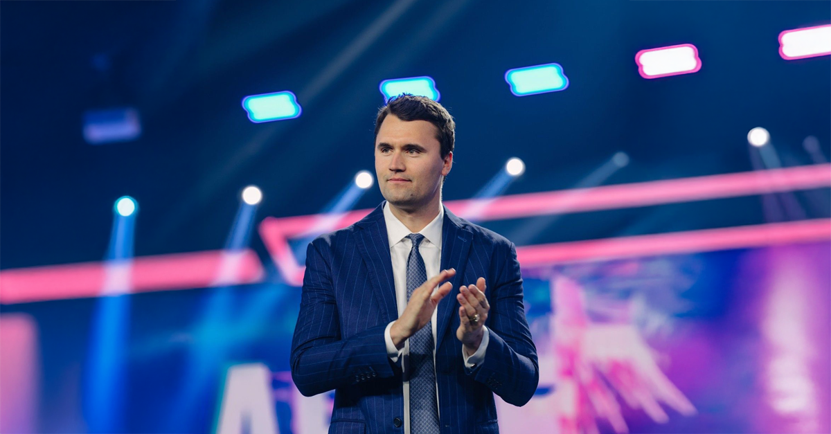 Charlie Kirk speaking at a conference filled with young people.