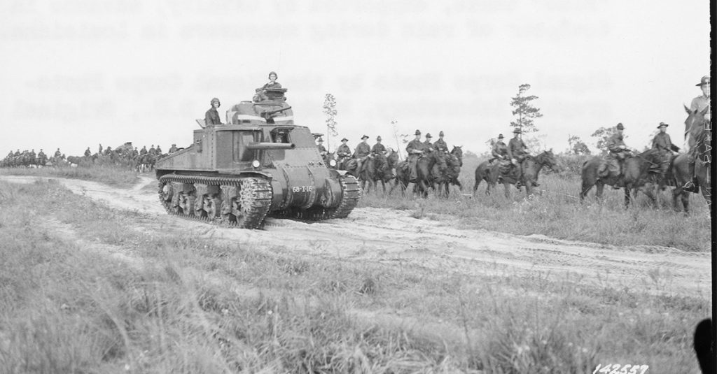Tanks and horses move over the open fields of Louisiana during the Army's training exercises of 1941