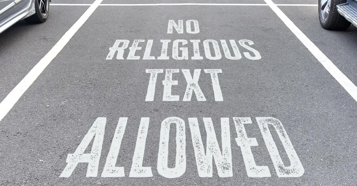 Parking space with painted words, "No Religious Text Allowed"