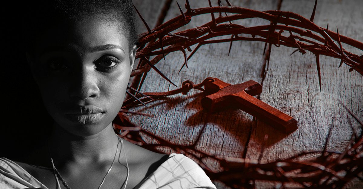 A persecuted Nigerian Christian against a backdrop of a small wooden cross and crown of thorns.