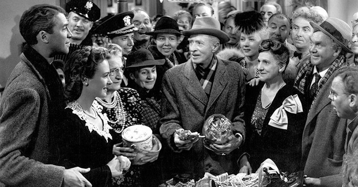 Scene showing George Bailey with members of Bedford Falls in the Christmas classic "It's a Wonderful Life."