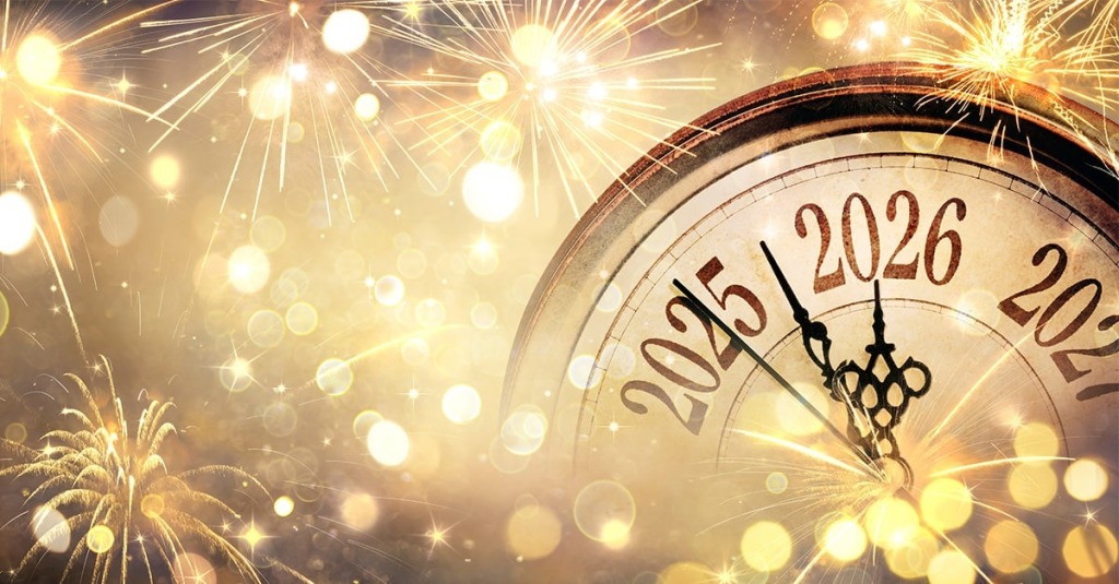 A clock surrounded by fireworks shows the year turning from 2025 to 2026.