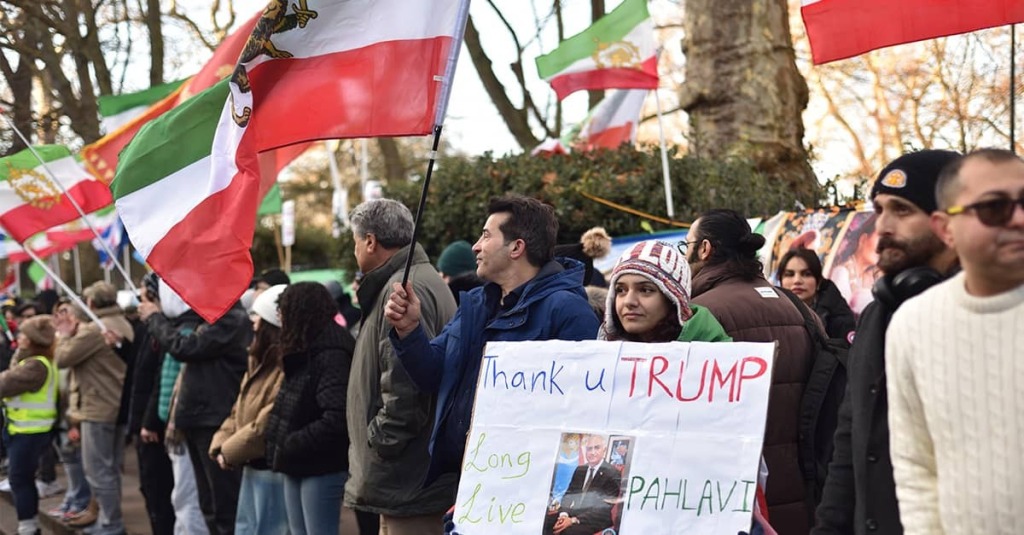 Protesters in London wave pre-Revolutionary Iranian flags and hold up a sign thanking President Trump for supporting the ongoing massive Iranian protests in Iran.