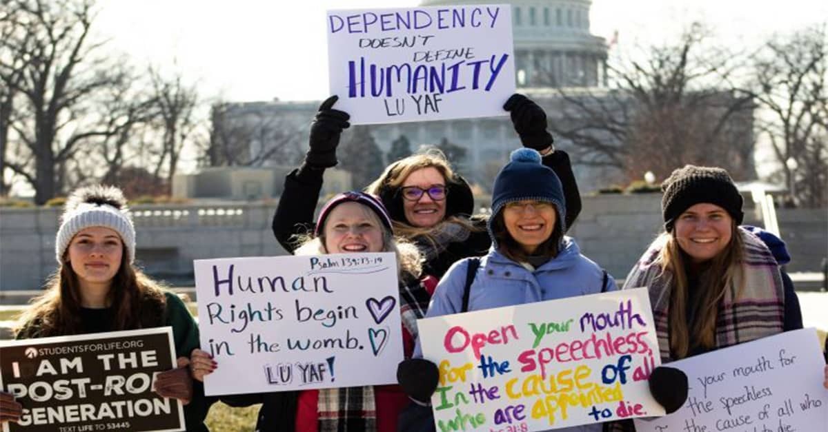 Liberty students hold up signs at March for Life in Washington, D.C.