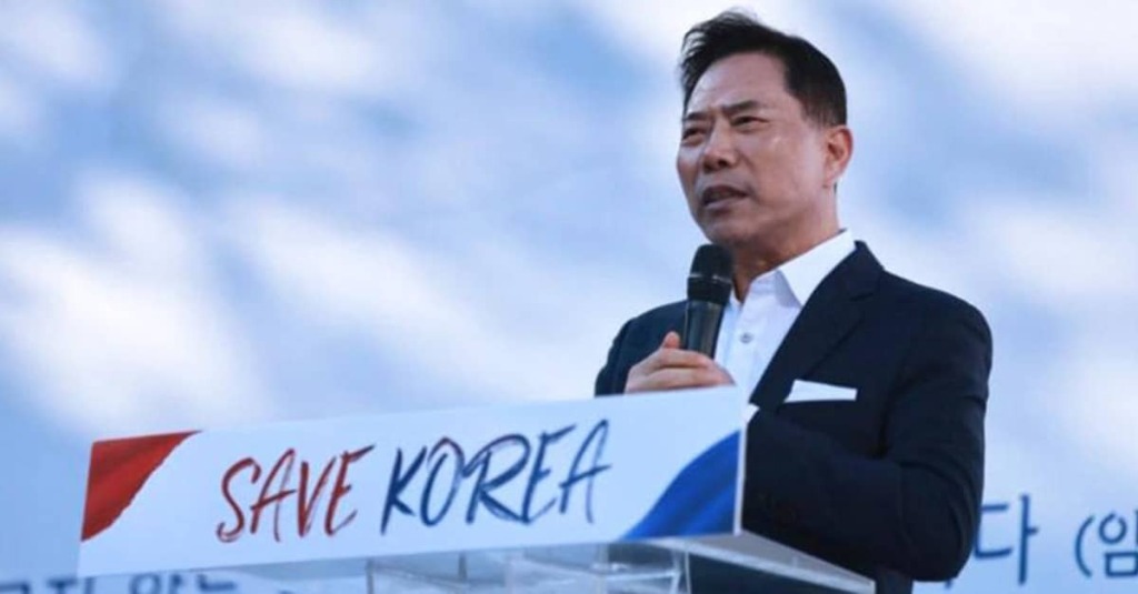 Pastor Hyun-bo Son gives a speech in front of a sign reading "Save Korea." opposing South Korea's Comprehensive Anti-Discrimination Law, which would ban pastors from preaching against