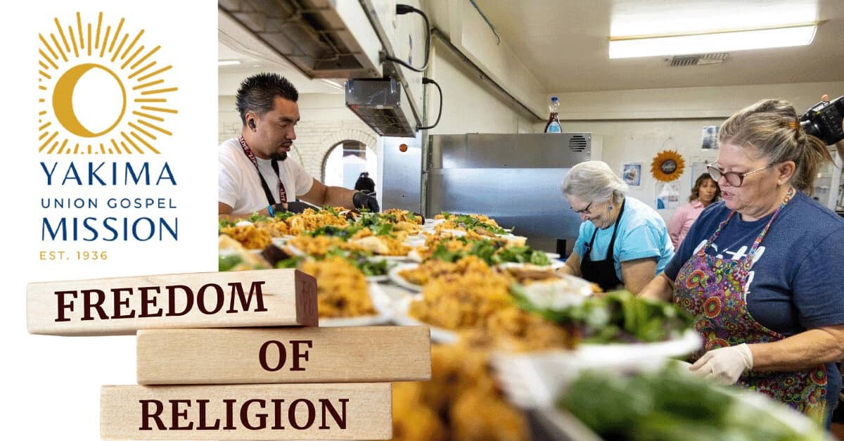 Yakima Union Gospel Mission volunteers serve meals beside “Freedom of Religion” books.