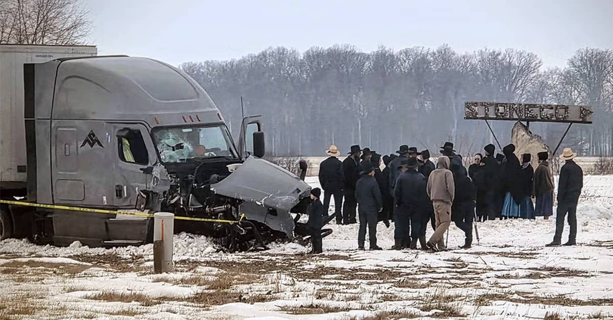 Members of the Amish community gather near a wrecked semi-truck that caused a crash on an Indiana highway that killed four Amish men.