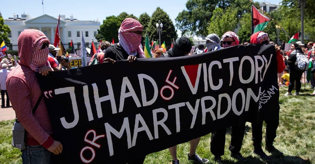 Keffiyeh-clad protesters call for global Islamic jihad in front of the White House in the aftermath of the October 7, 2023, attacks on Jewish civilians by Hamas terrorists. CREDIT: Shutterstock
