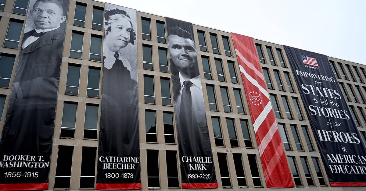 A banner of Charlie Kirk hangs next to Catharine Beecher and Booker T. Washington at the U.S. Department of Education as part of America's 250th Anniversary celebration.