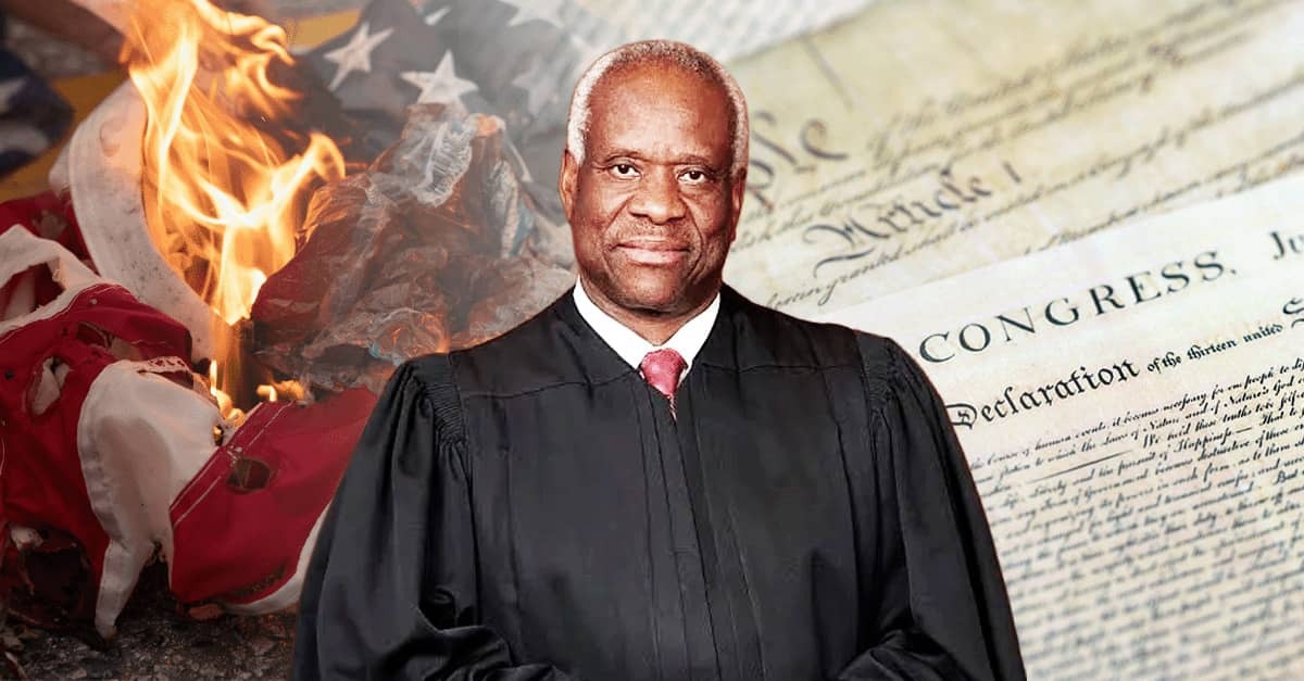 Justice Clarence Thomas in judicial robes stands before imagery of the U.S. Constitution and a burning American flag, symbolizing his warning about threats to America’s constitutional order.