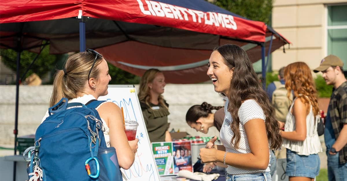 Josie Huyard, leader of the Freedom Center Society (FCS), talks with a prospective FCS member at last year’s "Picnic with Patriots" kickoff event on the Lawn at Liberty University.