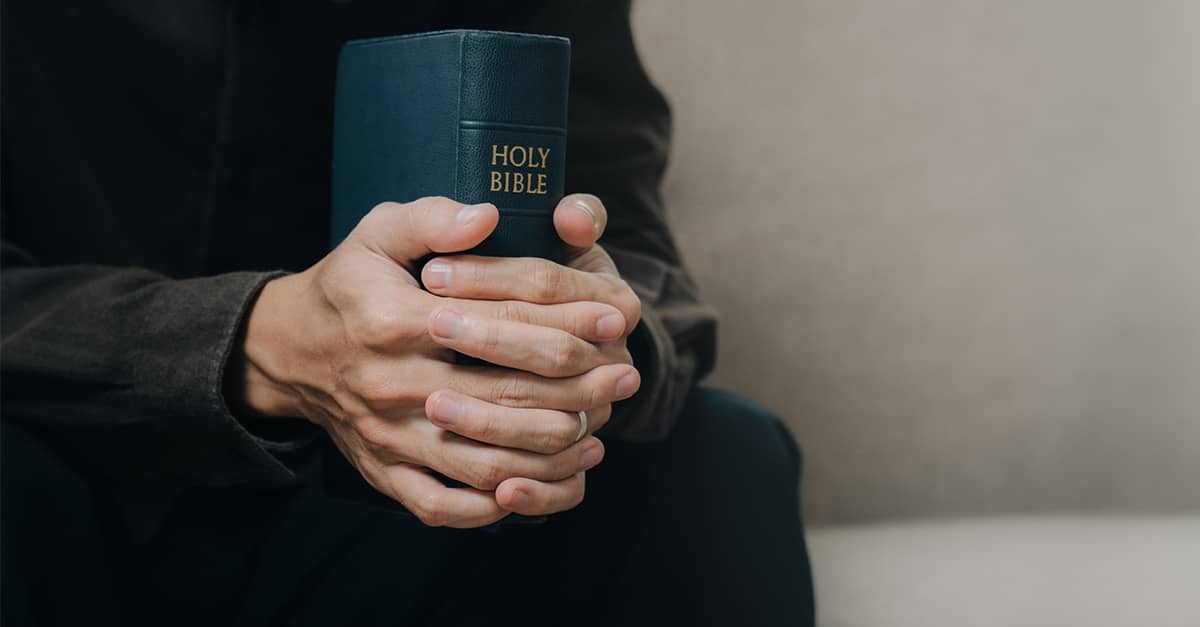 Young man holding a Bible